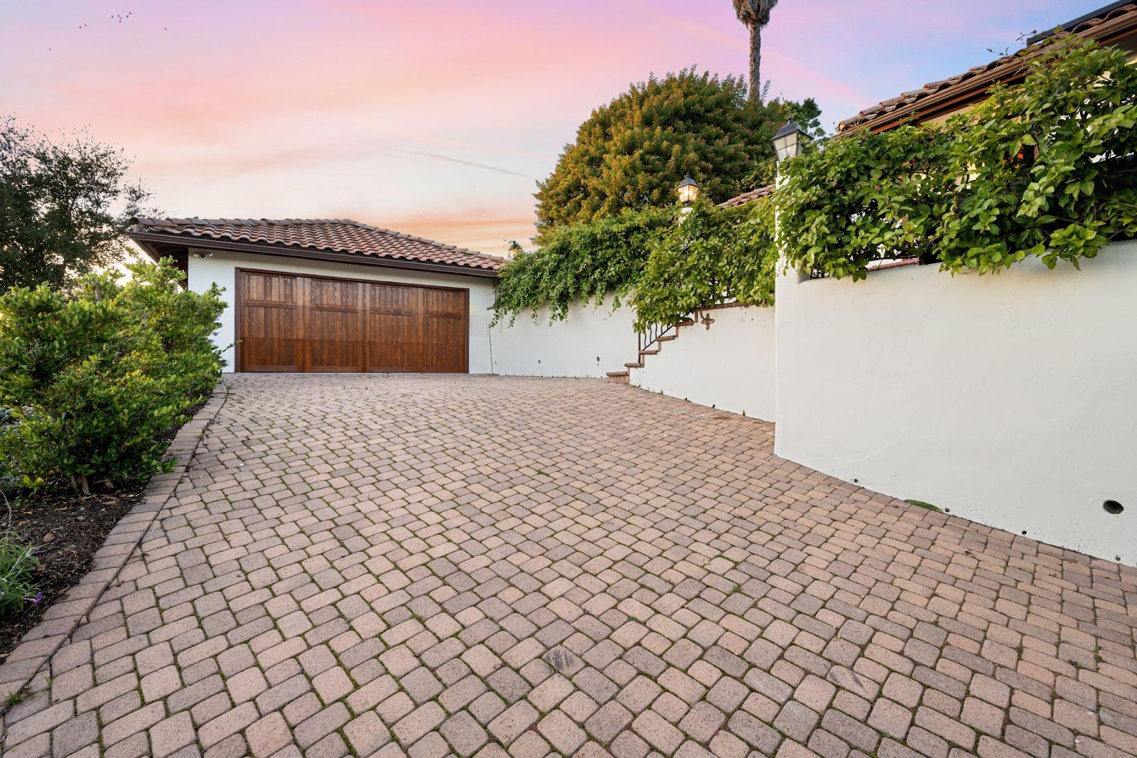 Brick paver driveway with a garage in the background