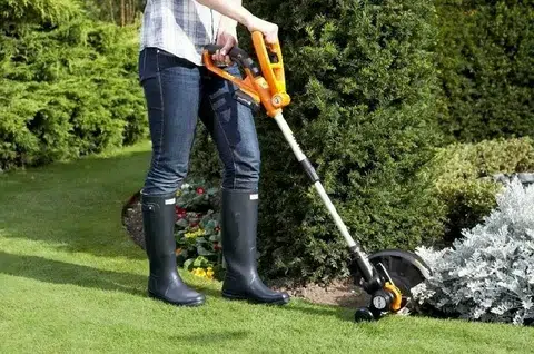 Describes Gardener Shaping Garden Plants Using Cordless Trimmer