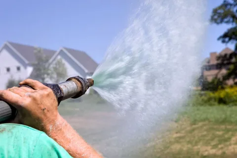 Watering newly installed fresh grass turfs
