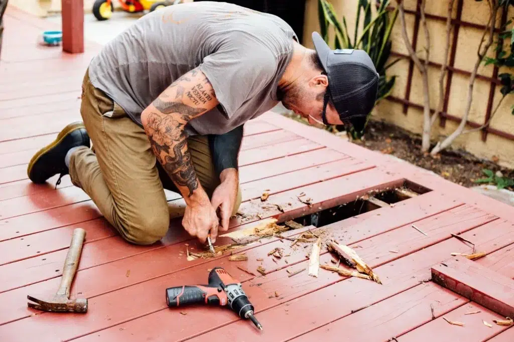 Guide on Man repairing wooden decking